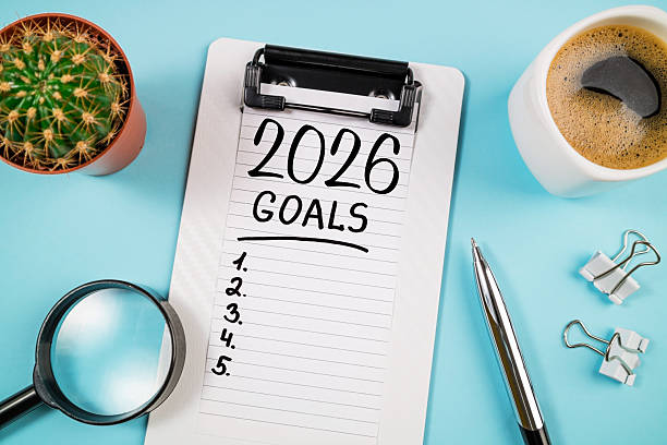 istock New year resolutions 2026 on desk. 2026 goals list with notebook, coffee cup, plant on blue table. Resolutions, plan, goals, action, checklist, idea concept. New Year 2026 resolutions 2219928992