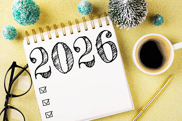 istock New year resolutions 2026 on desk. 2026 resolutions list with notebook, coffee cup, decorations on table. Goals, resolutions, plan, action concept. New Year 2026 template 2219929140