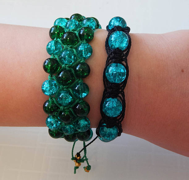 Female hand with green bracelets