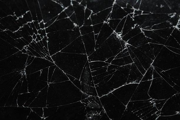 istock Pattern on cracked glass. damage to glass. broken or damaged background on glass wall 2219931792