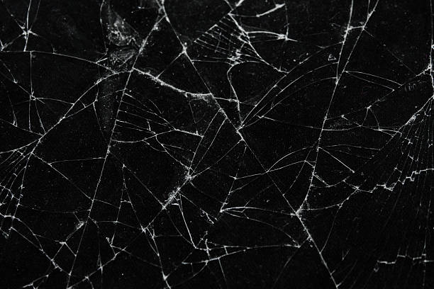 istock Pattern on cracked glass. damage to glass. broken or damaged background on glass wall 2219931799