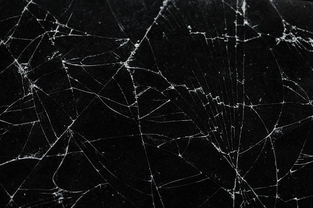 istock Pattern on cracked glass. damage to glass. broken or damaged background on glass wall 2219931823