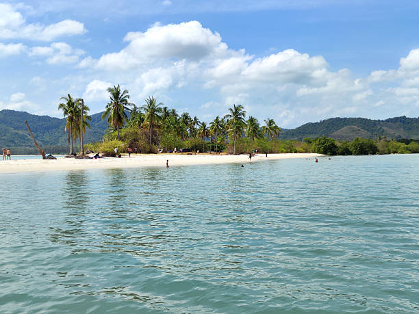 Tourists on the white sand at Laem Had beach in Ko Yao Yai, the larger of the two big islands in the Ko Yao Archipelago. The island group is in Phang Nga Bay in the Phang Nga Province of southern Thailand.