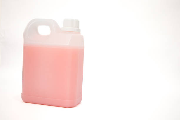 A plastic gallon container filled with pink liquid sits on a white background ready for use