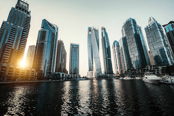 Modern Skyline of Dubai  Marina Skyscraper at dusk with Sunlight Reflecting on Waterfront Buildings