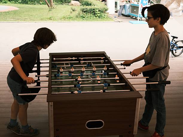 istock Two boys playing table football 2219939967