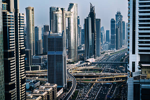 Densely packed skyscrapers and a bustling urban freeway along Sheikh Zayed Road in Dubai.