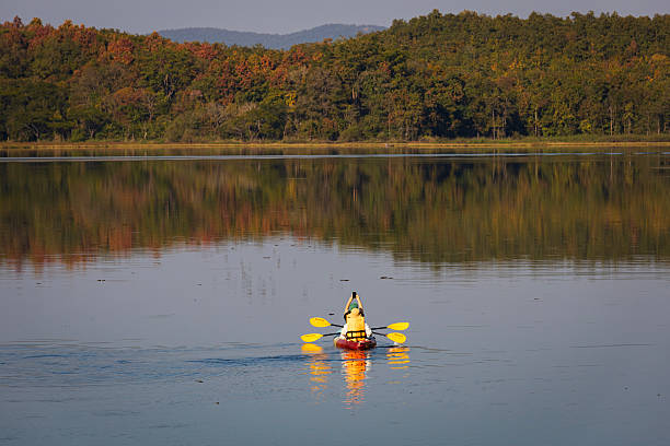istock Happy couple kayaking on lake 2219940386