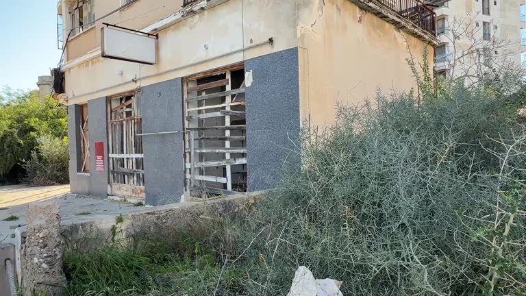 View of abandoned buildings and empty roads in the ghost town of Varosha, Famagusta, Cyprus, Former tourist destination now closed-off and decaying, Urban exploration and post-conflict documentary concept