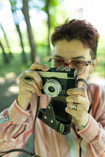istock Senior woman capturing moments using a classic analog camera. 2219943529