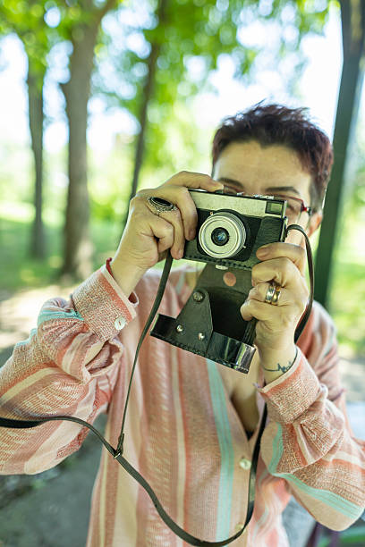 istock Senior woman capturing moments using a classic analog camera. 2219943532