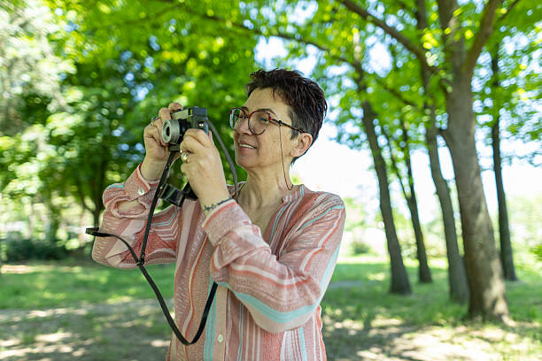 istock Senior woman capturing moments using a classic analog camera. 2219943549