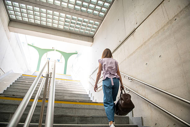 istock Woman going up the railway platform station underpass 2219944745