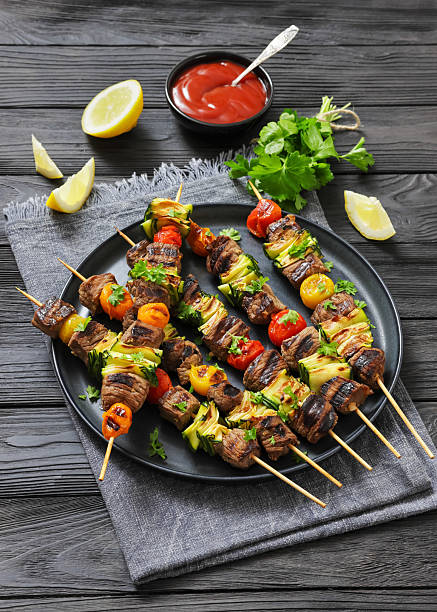 beef kebabs with zucchini and tomatoes on skewers