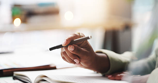 istock Pen, hand and person with notebook in home for studying with university test, exam or assignment. Stationary, closeup and student writing notes for research on college scholarship  application. 2219948810