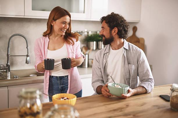istock Happy couple enjoying breakfast and coffee together in modern kitchen 2219949829