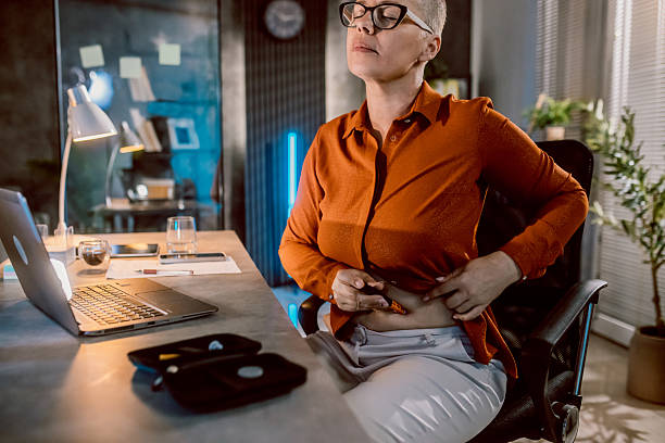 istock Businesswoman injecting insulin while sitting at desk in office 2219950067