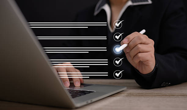 istock Performance checklist concept : businessman using finger with mobile phone for questionnaire, evaluation, assessment online or survey exam and filling out for digital survey and checklist. 2219950184
