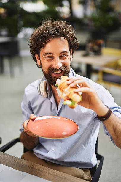 istock Cheerful entrepreneur enjoying a quick lunch break at a cafe 2219953907