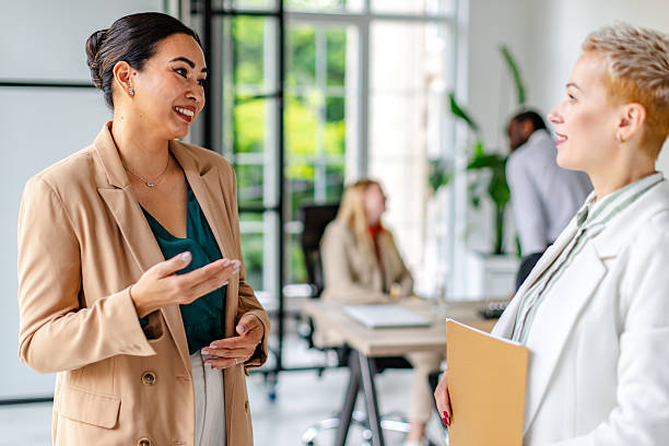 istock Professional adults engage in a collaborative discussion in a modern industrial office setting during work hours 2219955996
