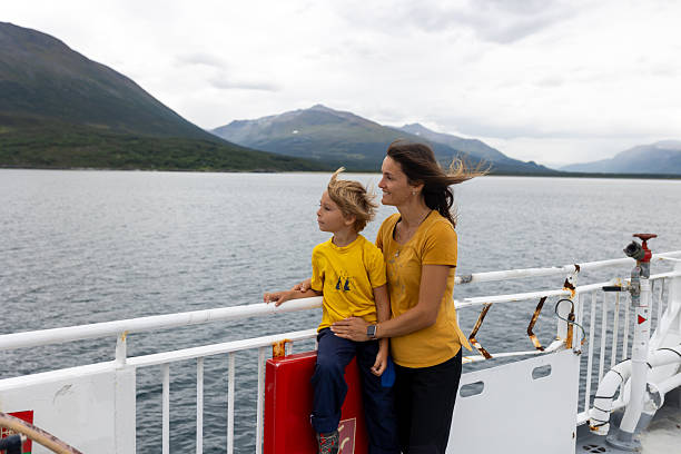 istock Child, cute boy, looking at the mountains from a ferry in Nortern Norway 2219956084