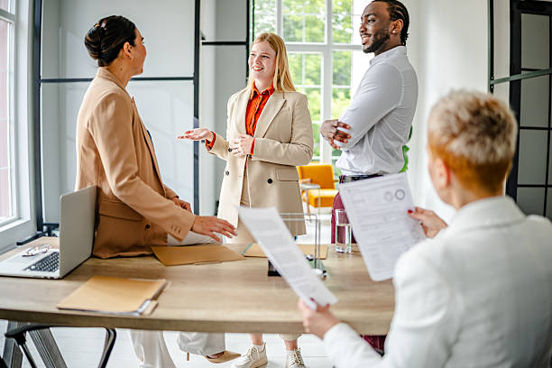 istock Professional adults engaged in a collaborative meeting in a modern office environment fostering teamwork and innovative ideas 2219956206