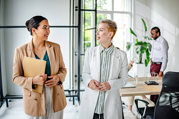 istock Professionals engage in discussion in a modern industrial office environment during a work meeting focused on collaboration and ideas 2219956506