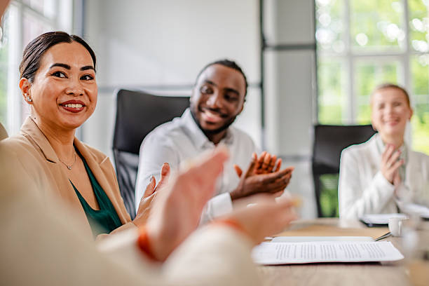 istock Team celebrates successful business meeting in modern office environment with enthusiastic participation 2219956737