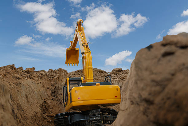 istock Back view of Excavator  are digging the soil. 2219957116
