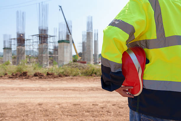 istock Asian architect engineer wearing safety uniform surveying and working at building structure checking blueprints construction site road general job details business concept architecture street 2219957541