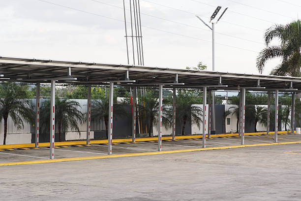 istock Empty parking area features a shade structure with palm trees lining the entrance. 2219957559