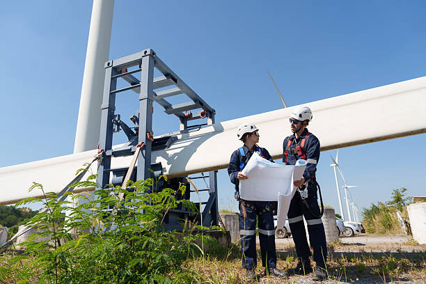 istock An engineer carefully examines a wind turbine blade at a construction site, placing a large blade on the ground to highlight the renewable energy technology. 2219957842