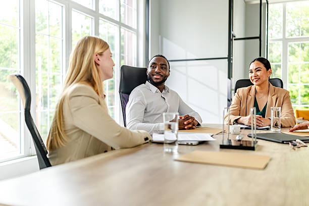 istock Discussion among business professionals in modern office setting focusing on collaboration and teamwork 2219958394