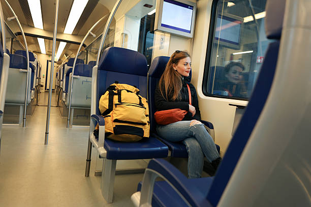 istock Young woman riding on a train 2219962918