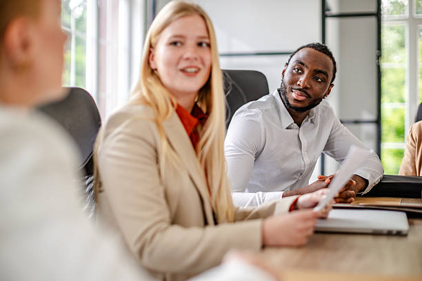 istock Business professionals collaborate in modern office during productive meeting among young adults 2219962966