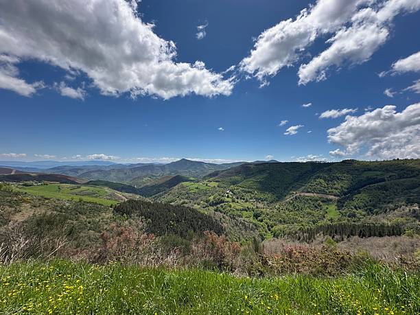 istock A grassy hill with hills in the background 2219963464