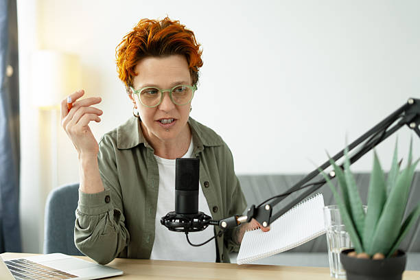 istock Middle aged female podcaster recording audio content at home studio 2219964172