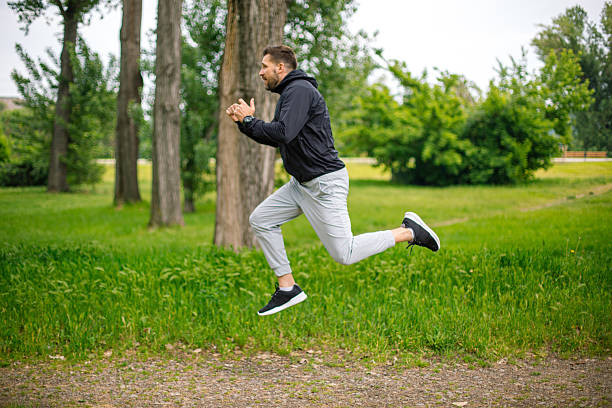 istock Young man leaping during a run in the park 2219965473