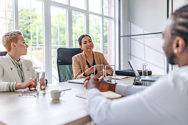 istock Collaboration between young business professionals in a modern office meeting environment 2219965741