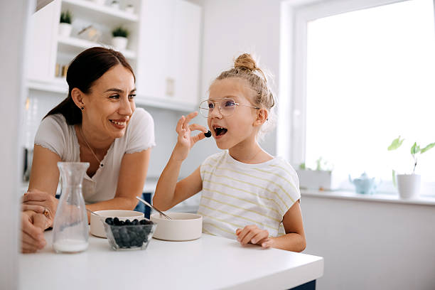 istock Mother and daughter are having breakfast. 2219965779