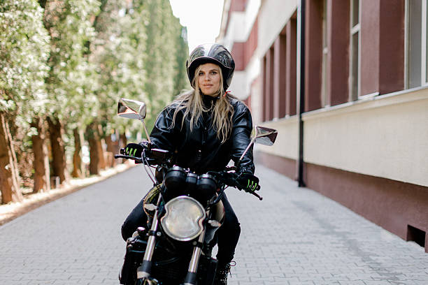 istock Young woman riding her motorcycle through a scenic forest path on a sunny day 2219966812
