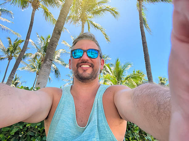istock Tourist taking a selfie in Miami Beach, Florida, under palm trees 2219967643