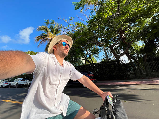 istock Tourist riding a bicycle and taking a selfie in Miami Beach 2219967742