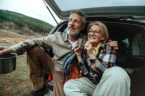 istock Active mature couple having a warm drink after hike in nature 2219968667