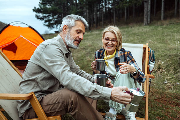 istock Mature couple enjoying coffee while camping in nature together 2219968861