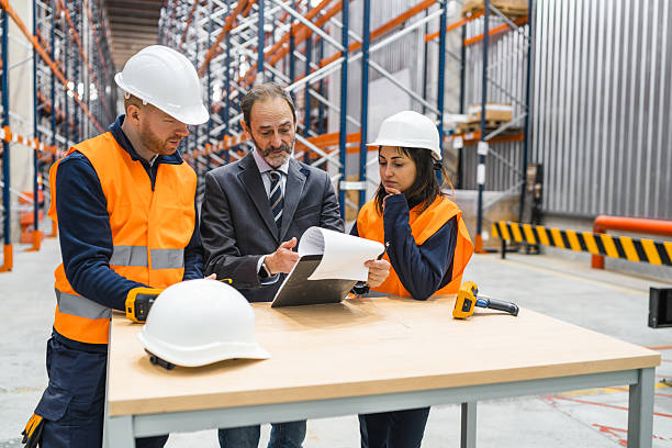 istock Warehouse workers and manager reviewing inventory checklist 2219969137