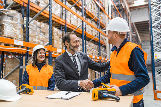 istock Entrepreneur shaking hands with a warehouse worker in logistics center 2219969156