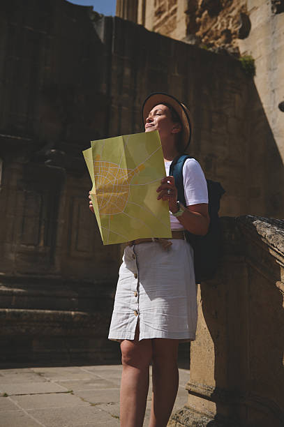 istock Woman Exploring a Historic City with a Map on a Sunny Day 2219969263