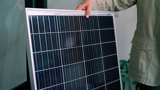 istock Young Asian salesman advertising a solar panel during a client meeting at the office. 2219969501