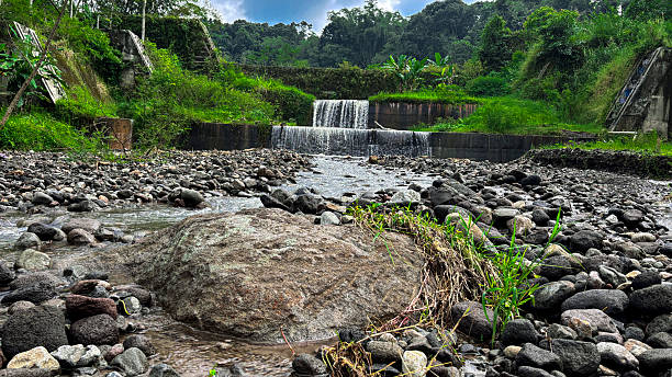 istock Small Waterfall and Rocky Stream in Tropical Landscape with Overcast Sky 2219974451